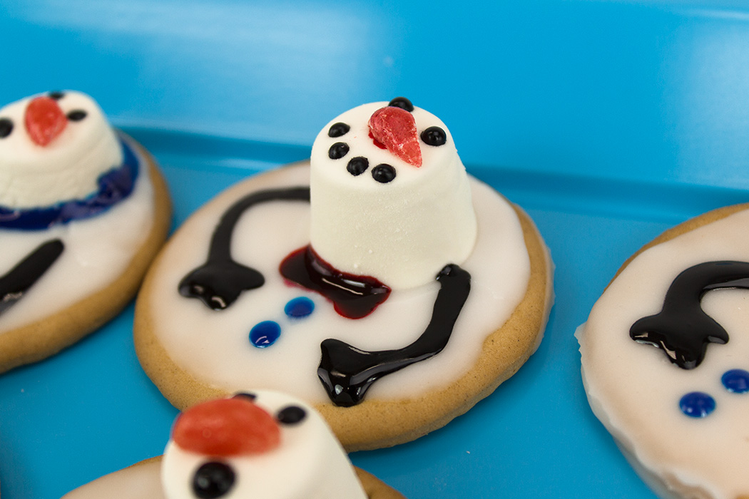 home-made cookies with a marshmallow and icing topping made to look like a snowman