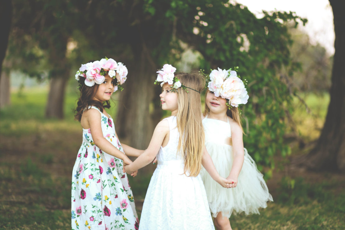 children girls holding hands in the garden