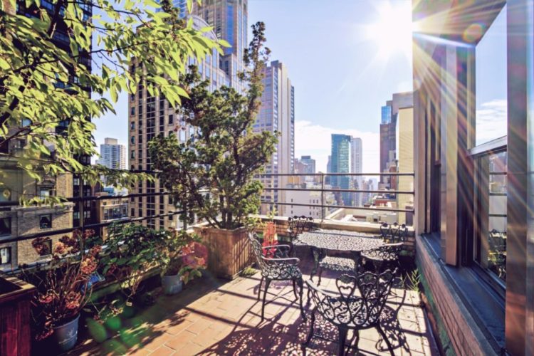 A balcony garden in New York, filled with plants and patio furniture