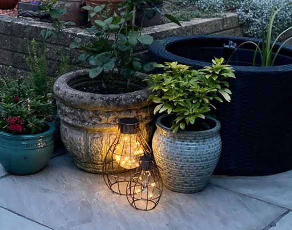 two lanterns filled with delicate fairy lights. The effect is magical.