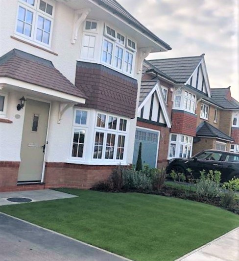 A conventional British home with artificial grass in the front garden