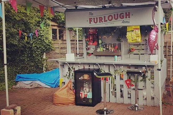 A garden bar with a sign saying the Furlough Arms