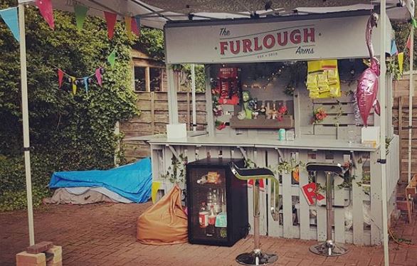 A garden bar with a sign saying the Furlough Arms