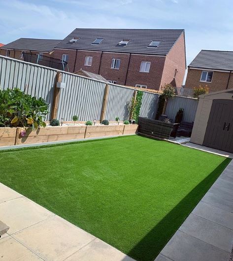 An immaculate rectangle of synthetic lawn. It's perfectly level and a very even shade of green.
