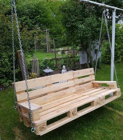 A DIY garden swing bench made from stripped wooden pallets