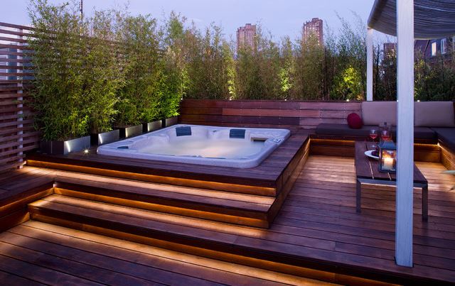 a luxurious sunken hot tub on a wooden deck in London