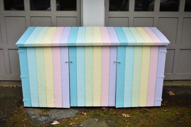 13 Outdoor Toy Storage Ideas for Any Garden Style 3 An outdoor bin store unit that's been painted in pastel rainbow shades to be used as toy storage