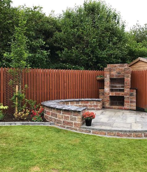 a circular patio with in-built seating and bbq
