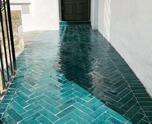 8 Morocco Garden Ideas to Design Your Own Moroccan Courtyard 9 a front door with a path made from glossy turquoise tiles in a herringbone pattern - the effect is very water-like