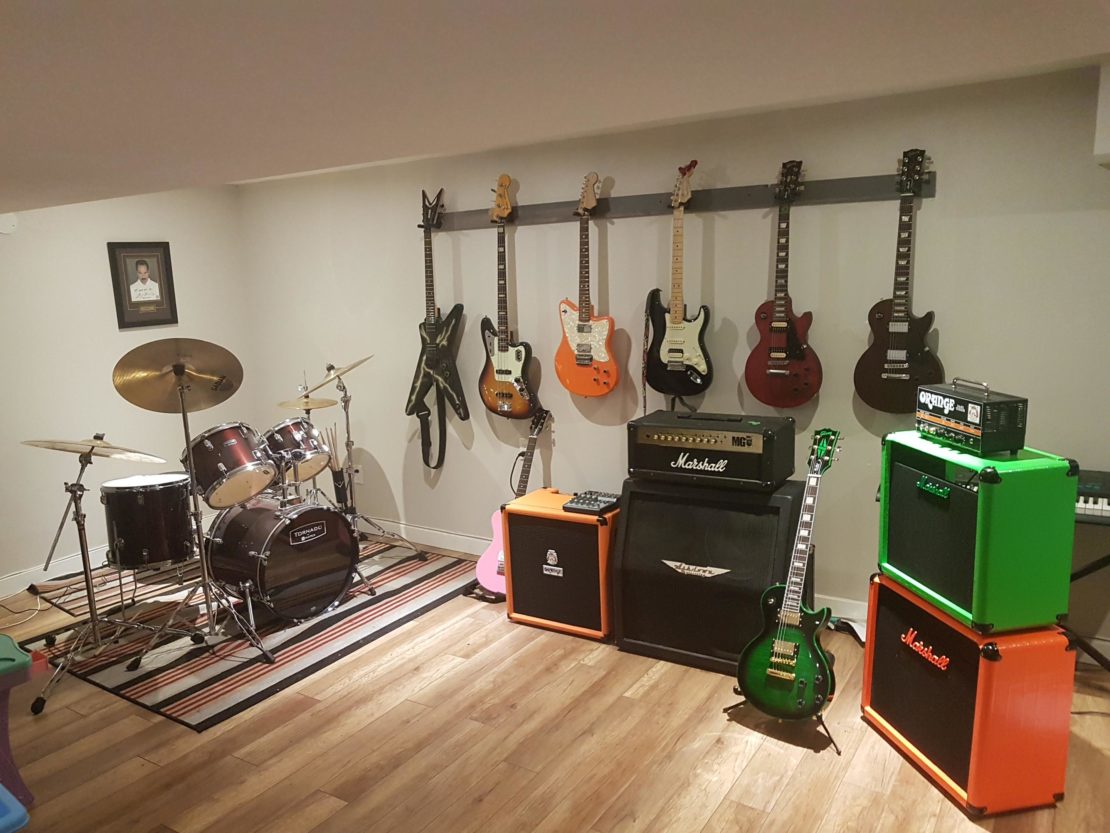 23 Cool Garden Man Cave Ideas to Pimp Your Outdoor Shed 7 a music focused man cave, with drum kit, several big amps and multiple guitars hanging on the wall