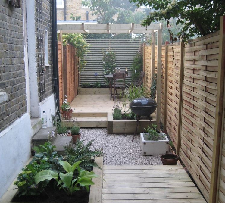 a narrow side-garden divided into sections of decking and gravel, making each area more practical