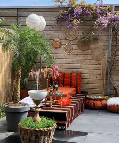 8 Morocco Garden Ideas to Design Your Own Moroccan Courtyard 12 a patio with a low table covered in patterned cloth, and low pouffes and beanbags surrounding it