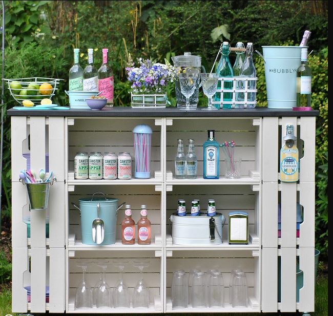 a pretty garden bar stocked with soft drinks, fruit and decorated with flowers