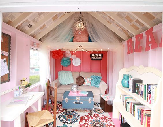 40 Garden Shed Ideas for Pretty to Practical Outdoor Buildings 28 a quirky she shed interior, painted contrasting shades of pink and red, with a sofa, bookshelf and desk