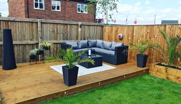 a raised deck with in-built lights and a large, black corner seat