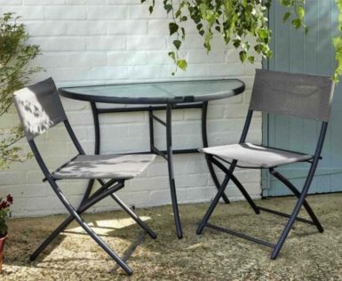 a semicircular table against a wall with two slimline folding chairs