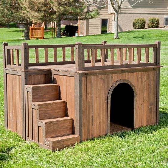 Outdoor Dog Area Ideas For a Puppy-Friendly Garden Paradise 12 a two-storey DIY dog house in a garden