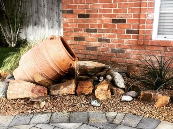 14 Stunning Garden Water Feature Ideas: Finding a Fountain for Your Home 3 garden water feature ideas using a clay pot amphora fountain on its side, pouring into gravel