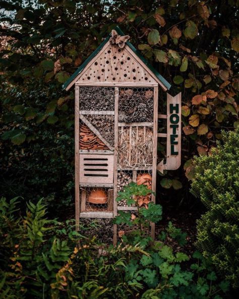 garden bug hotel ideas - a small insect hotel with a little hotel sign on the side
