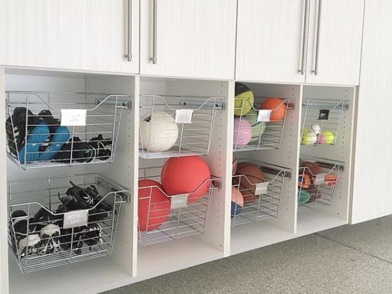 13 Outdoor Toy Storage Ideas for Any Garden Style 5 open shelving with wire drawers filled with sports balls of all sizes