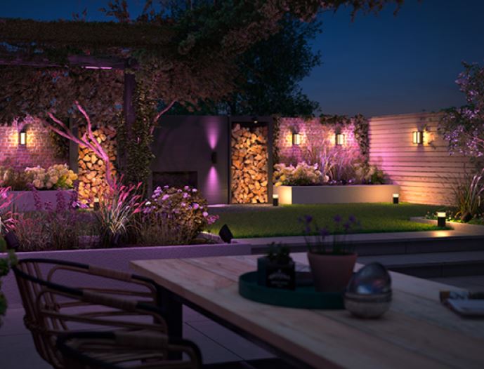 a stylish garden with multiple lights set to different colours and intensities
