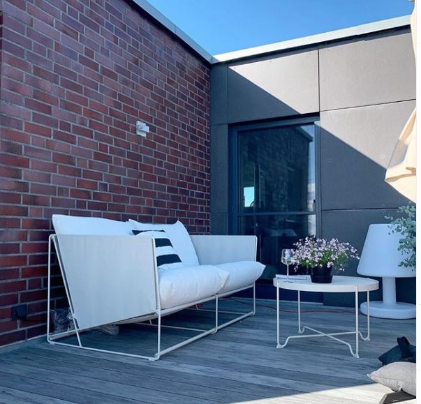 15 Roof Garden Ideas to Design Your City Escape From Chaos 9 rooftop terrace ideas - wooden floor and brick walls, with slimline sofa and coffee table