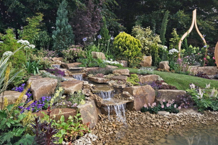 14 Stunning Garden Water Feature Ideas: Finding a Fountain for Your Home 13 an elaborate but natural looking rock waterfall garden feature