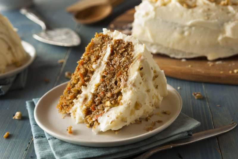 a wedge of home made carrot cake with thick icing