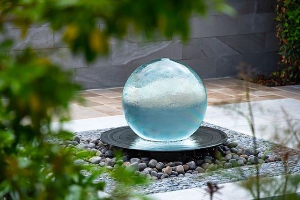 14 Stunning Garden Water Feature Ideas: Finding a Fountain for Your Home 4 a spherical garden fountain with water gently flowing over it