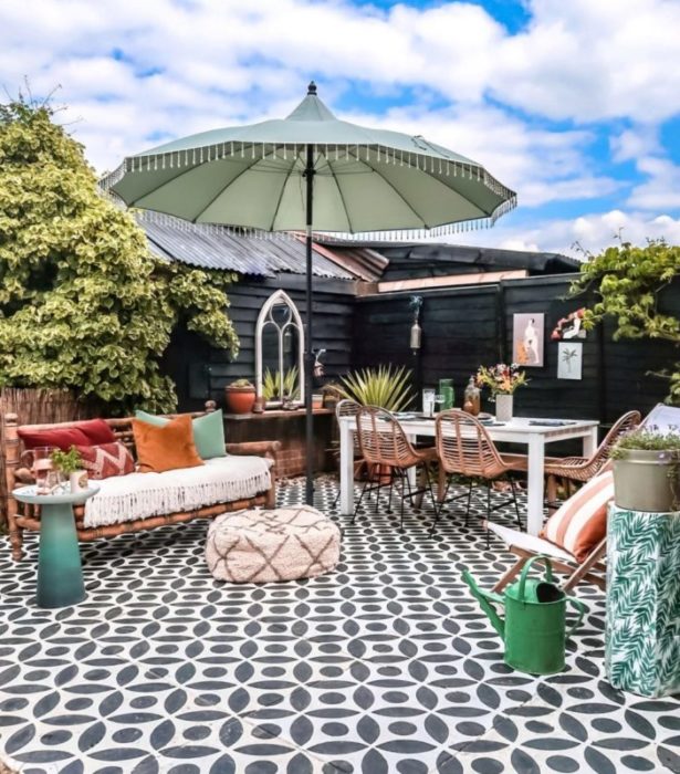 a concrete patio with a black and white pattern painted across it
