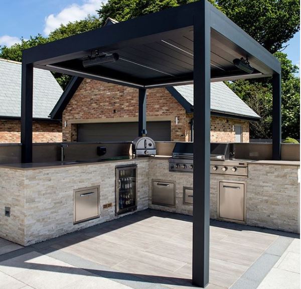 20 Garden Kitchen Ideas For The Perfect Outdoor Cooking Area 10 a black steel pergola with a sleek contemporary outdoor kitchen beneath