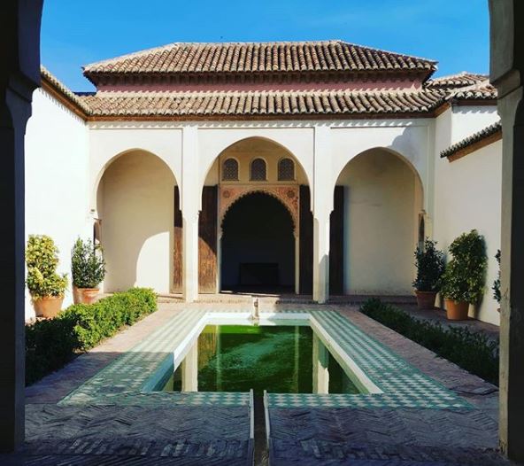 Spanish Themed Garden Ideas: Turn Your Garden into a Sizzling Iberian Sanctuary 12 a Spanish style courtyard with a long central pool and brightly patterned tiles