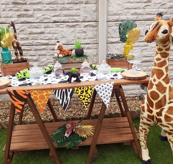 a party food table with animal-print bunting and safari decor