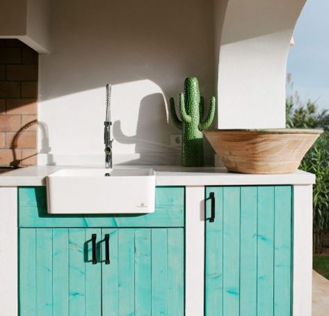 20 Garden Kitchen Ideas For The Perfect Outdoor Cooking Area 9 an outdoor kitchen with stucco walls and wooden cupboards stained turquoise