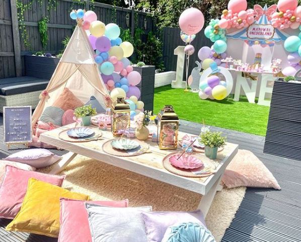 pastel coloured kids garden party ideas with balloons and floor seating