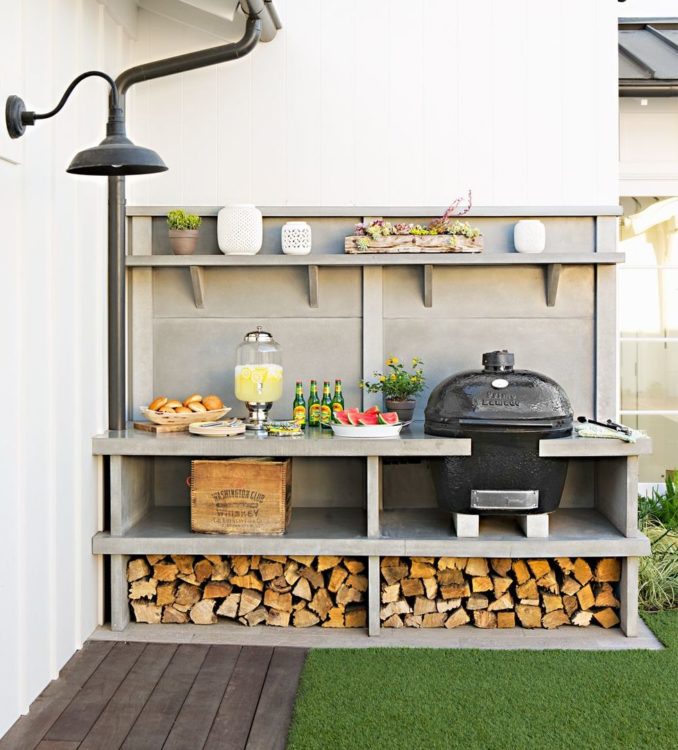 20 Garden Kitchen Ideas For The Perfect Outdoor Cooking Area 13 a narrow outdoor kitchen with a kamado cooker and wood store