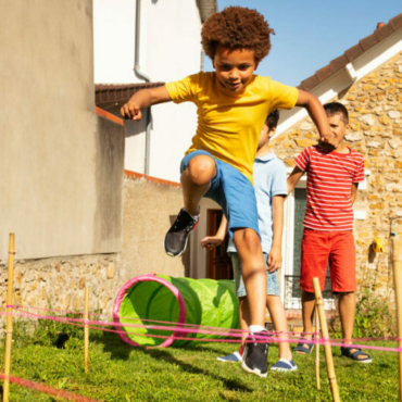 race with obstacles child jumping over hurdle