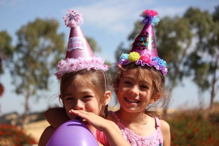 two girls in party hats