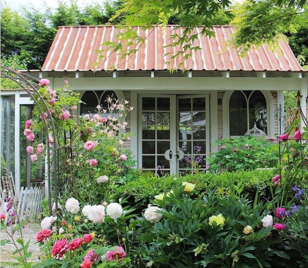40 Garden Shed Ideas for Pretty to Practical Outdoor Buildings 8 a pretty green shed with church style windows