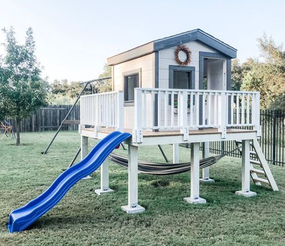 40 Garden Shed Ideas for Pretty to Practical Outdoor Buildings 37 a shed on a raised platform, with a ladder and slide