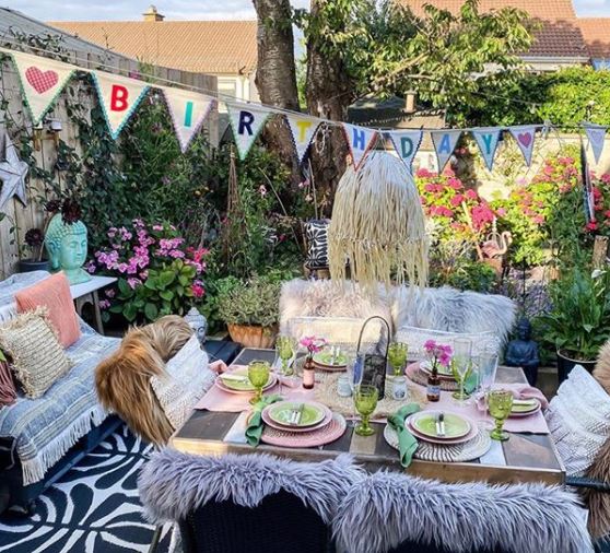 cosy patio seating with rustic bunting that says "happy birthday"