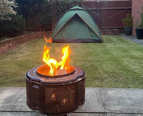 20 Fun & Adventurous Garden Camping Ideas For the Family 1 a modern green tent in a garden and a fire pit burning outside