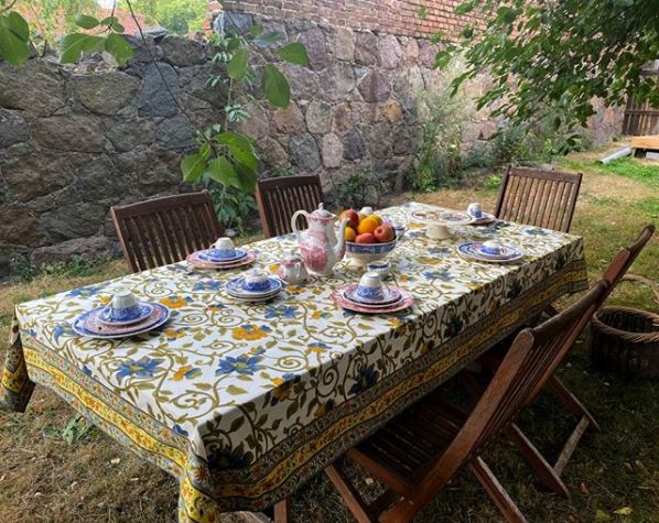 20 Fun & Adventurous Garden Camping Ideas For the Family 15 a cosy outdoor table with a floral, bohemian tablecloth