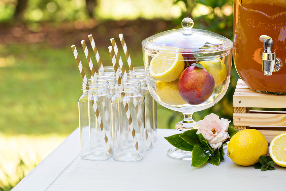 garden party refreshments table with a bowl of fresh fruit and empty glasses