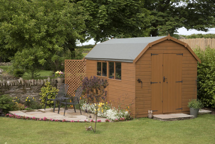 a large brown garden shed with double doors