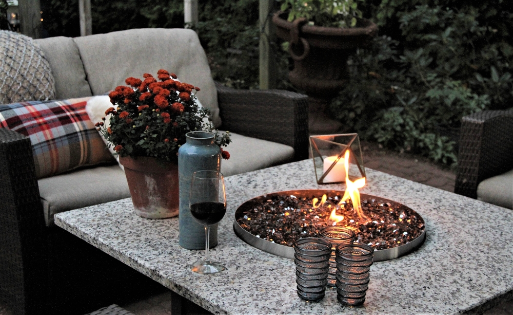 29 Garden Fire Pit Ideas for Cosy Evening Get-Togethers 13 a small round fire pit in a stone topped coffee table