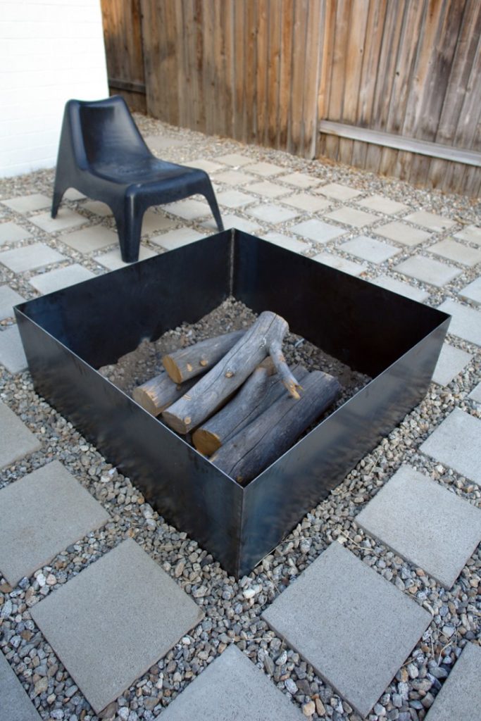 a DIY square metal fire pit on a patio