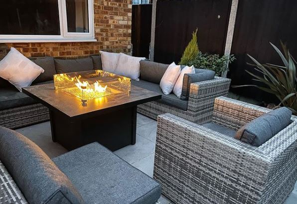 a gas fuelled ire pit style coffee table on a patio