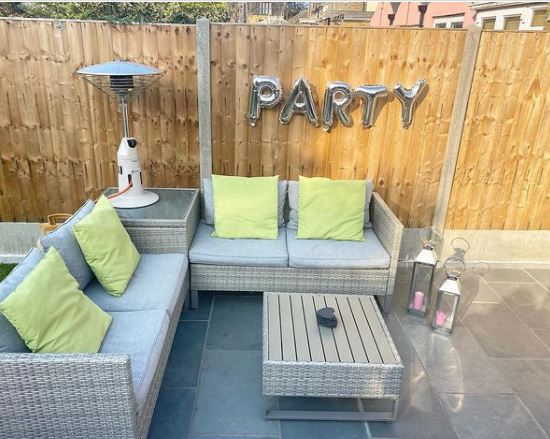 a tabletop gas patio heater on a coffee table between two sofas