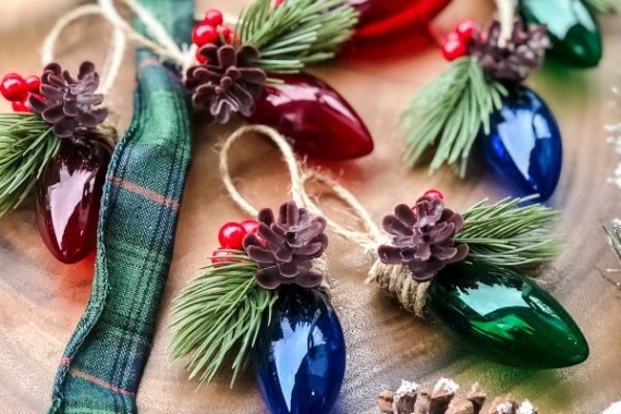 a string of vintage fairy lights with festive elements like pinecones and fir sprigs added